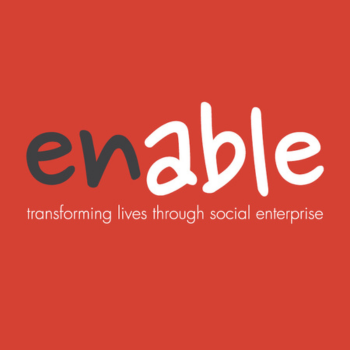 Logo for Enable with the tagline “transforming lives through social enterprise” on a red background, featuring playful black and white lettering.